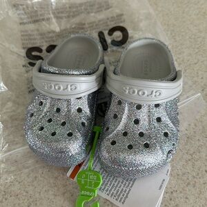 Toddler silver crocs 
New with tags